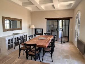 ein Esszimmer mit einem Holztisch und Stühlen in der Unterkunft Luxury Villa and Panoramic View in Spéracèdes in Spéracèdes