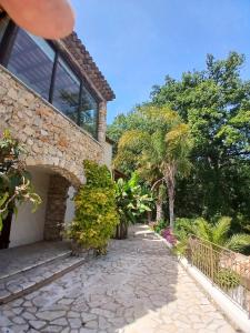 ein Haus mit einem Steinweg und Bäumen in der Unterkunft Luxury Villa and Panoramic View in Spéracèdes in Spéracèdes