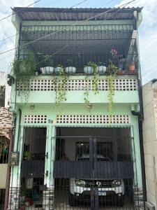 a building with potted plants on top of it at Casa do Marco&Leoni in Belém