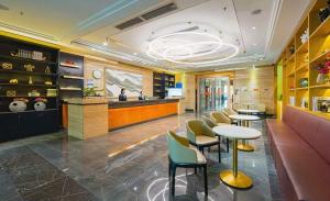 a restaurant with tables and chairs and a bar at Fa万濠国际服务公寓 广州琶洲会展中心店 in Guangzhou