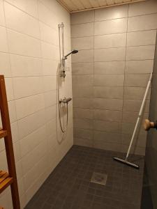 a shower in a bathroom with a tile floor at Kottaraispari in Imatra +2 photos