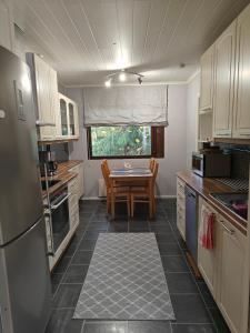 a kitchen with a table and a dining room at Kottaraispari in Imatra