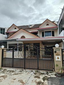 a house with a black fence and a porch at GHome Cheerful comfort home in Butterworth