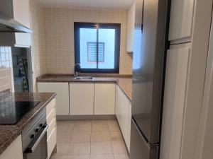 a kitchen with a sink and a window at Spacious 6-bed Apartment in Marina de la Alcaidesa in Alcaidesa