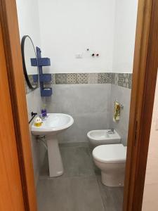 a bathroom with a sink and a toilet at A pantanello da Nuzzo in Avola +2 photos