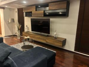 a living room with a flat screen tv on a wall at Pranaluxe Pool Villa ORG in Pran Buri