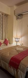 a bedroom with a bed with a lamp on it at Mayabini Homestay 3BHK in Guwahati