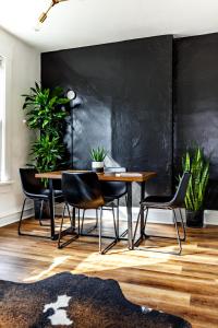 a dining room with a table and chairs and plants at Short North Convention Private Parking Pets! in Columbus