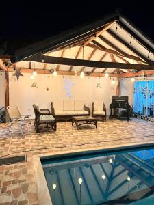 a patio with a couch and a piano at Cabaña Ivan in Santa Marta