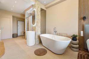 a bathroom with a large tub and a sink at Nice Renting - HUGO - Luxury Honeymoon Suite Terrace Park View Free Parking in Nice +19 photos