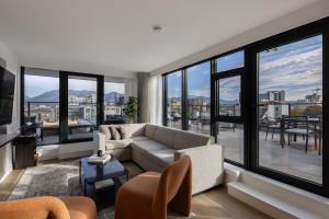 a living room with a couch and large windows at Keefer House in Vancouver