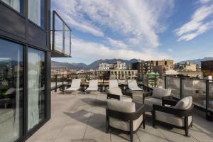 a balcony with chairs and a view of a city at Keefer House in Vancouver