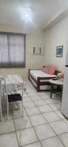 a bedroom with a bed and a table and chairs at Angra inn - Angra dos Reis - apê120 in Angra dos Reis +70 photos