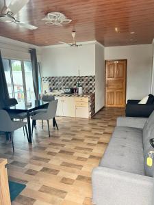 a living room with a couch and a table at Heyleez Guest House in Himmafushi