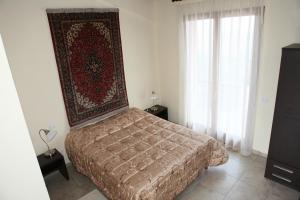 a bedroom with a bed with a rug on the wall at Agriturismo Apollinare in Montiano