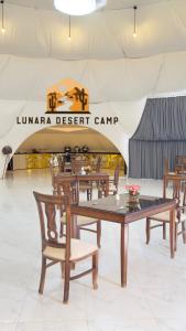 a tent with tables and chairs and a sign that reads luna desert camp at Lunara Desert Camp in Wadi Rum +63 photos
