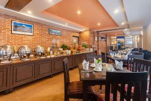 un restaurant avec des tables et des chaises dans une salle dans l'établissement Mount Kailash Resort, à Pokhara 162 autres photos