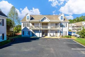 a large white house with a parking lot at Park Place on the Plains in Auburn