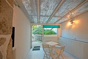 une pièce avec une table, des chaises et une fenêtre dans l'établissement Gîte Estable - Village De Gîtes, à Rosières