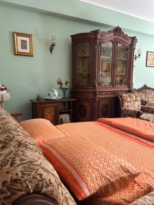 a bedroom with a large wooden cabinet and a bed at Saturno Casa Vacanza in Milazzo