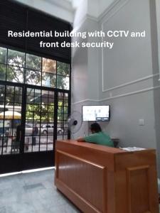 a person sitting at a desk in an office at Cozy and comfort bedroom in a private Fancy Condo, safety neighborhood only 20 minutes by car from event - COP30! in Belém