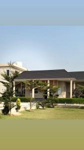 a large house with a roof on top of it at Haven farmstays in Amritsar