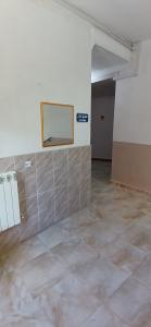 an empty room with a mirror on the wall at hostel 1er novembre khenchela in Khenchela