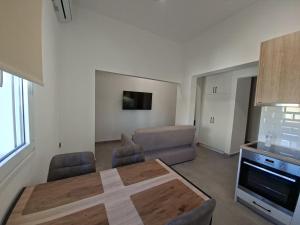 a living room with a table and a couch at Authentic appartement in Aíyira