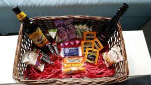 een mand gevuld met bier en snacks op een tafel bij Mountain Lodge, Lake View, National Park in Borrowdale Valley