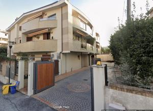 a building with a gate in front of it at Residence "Elena e Valerio" in Pescara
