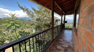 a balcony with a view of the mountains at Hospedaje, La Florida - Tour De Cafè Y Abejas in Jardin