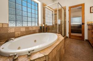 a large bathroom with a tub and a window at Splendid 3BR Cottage Sleeps 10 Ideal Location for Key Attractions Great Value Lots of Amenities in Williams +41 photos