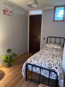 a bedroom with a bed with a comforter at Ca' Dei Sassi in Segusino