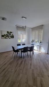a dining room with a table and chairs in a room at Sunny CentralApartment -3 bedrooms ,Private Parking in Monfalcone
