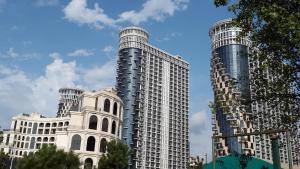 two tall white buildings next to each other at Sea Towers 2107 in Batumi