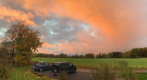 two cars parked in a parking lot under a cloudy sky at Gîte Banet-Sart à Daverdisse in Daverdisse