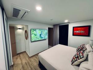 a hotel room with a bed and a couch at Vistas del Bosque Jacó in Jacó +45 photos