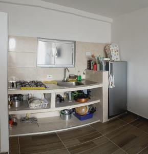 a kitchen with a sink and a refrigerator at Apartamento amoblado in Girardot