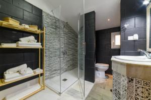 a bathroom with a shower and a sink and a toilet at Chalet Copos Nevados by Surynieve in Sierra Nevada +19 photos