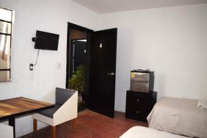 a room with a bed and a desk and a television at Bounaterra Lofts in León +18 photos