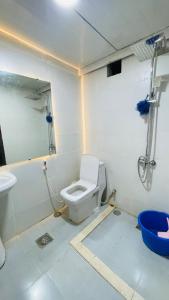 a bathroom with a toilet and a sink at Fully furnished bedroom c-136 in Abu Dhabi