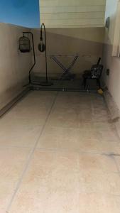 a room with a gym with a treadmill and a chair at Fully furnished bedroom c-136 in Abu Dhabi +11 photos