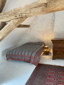 a bedroom with a bed in a attic at La maison du moulin in Lurcy-le-Bourg