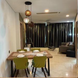 a dining room table and chairs in a living room at Vortex luxury apartment by KL in Kuala Lumpur