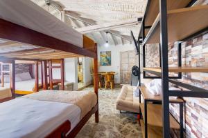 a bedroom with two bunk beds and a brick wall at Hotel Glamping La Polka in Amagá +290 photos