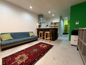 a living room with a couch and a kitchen at uchimachi201 しげの里リノベーション52平方メートルJR高松駅14分ことでん片原町駅3分土足OK in Takamatsu