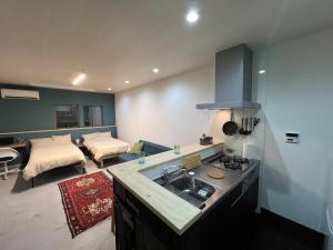 a kitchen with a sink and a living room at uchimachi201 しげの里リノベーション52平方メートルJR高松駅14分ことでん片原町駅3分土足OK in Takamatsu