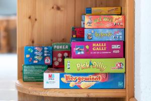 a stack of books sitting on a shelf at Ferienwohnung in Strittberg mit Sauna und Alpenblick in Höchenschwand