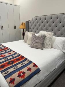 a bedroom with a bed with a tufted headboard at RMR: Four Seasons I 6 Condo in Teton Village in Teton Village