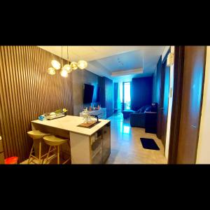 a kitchen and living room with a table and chairs at 31 Sudirman Suites in Makassar